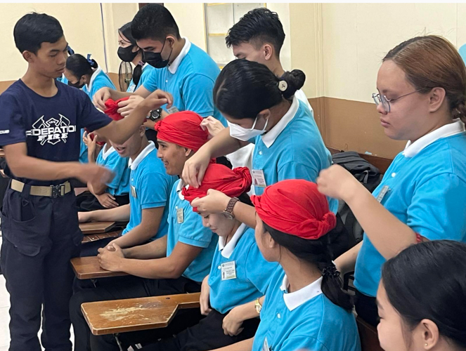 A guest speaker teaches Tzu Chi Iloilo scholars the proper way to wrap a head wound in Humanity class on disaster preparedness. Forty scholars attended the Humanity class.【Photo by Tzu Chi Iloilo】