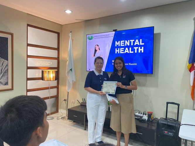 In Zamboanga, mental health guest speaker Jeina Lynne I. Nambli, RPM - SHS Guidance Counselor (right) receives a certificate of appreciation after her talk.
