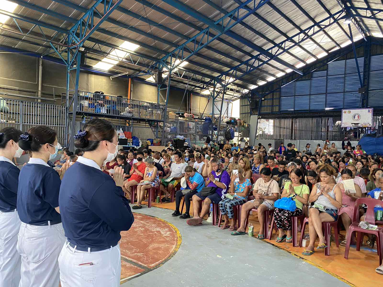 Before the distribution of GI sheets, a moment of silence to pray in gratitude for the help that is about to be given and received.