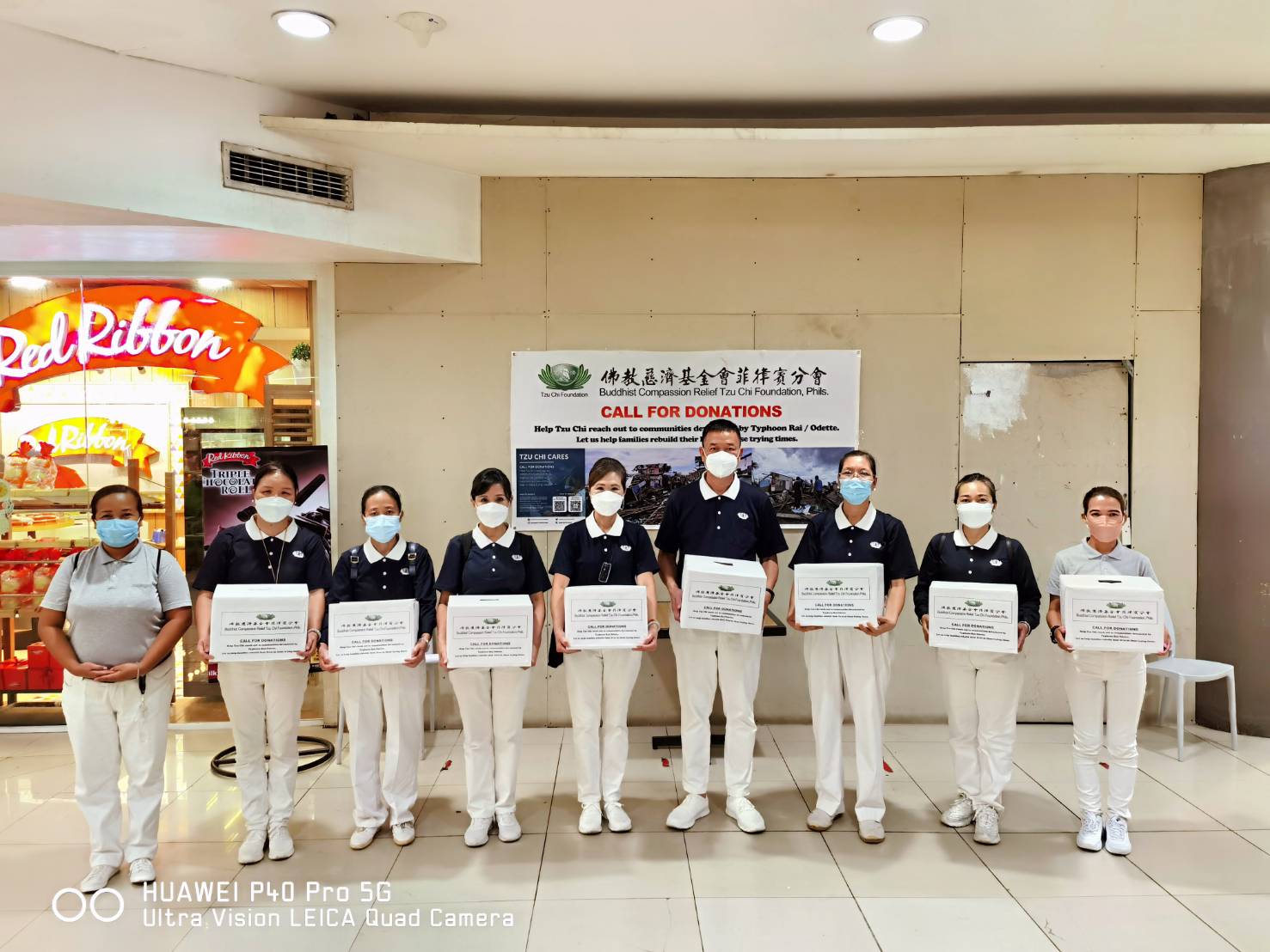 The team of Tzu Chi volunteers and their collection boxes at the Gaisano Mall in Davao City. 