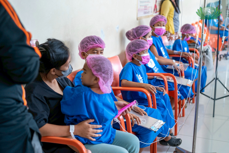Children wait in line for their surgeries.