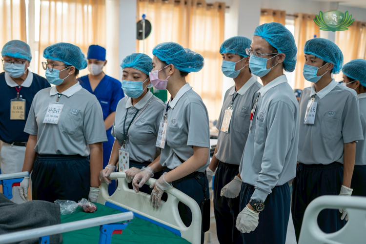 Student volunteers from Tzu Chi University in Taiwan observe the ongoing medical mission.