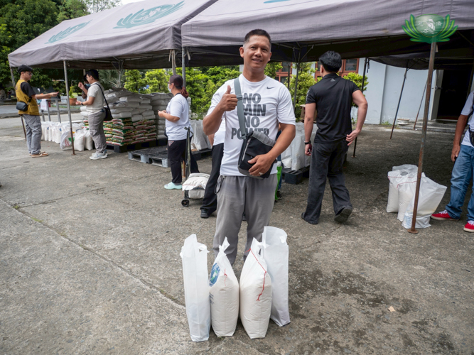 Michael Molve claims his 20 kg rice and groceries after attending Charity Day on December 14.