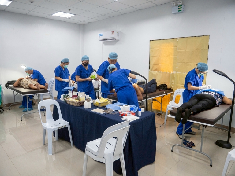 Minor surgical procedures are performed simultaneously by TIMA’s volunteer doctors in a makeshift operating room at the Victoria Plaza Hotel in Victoria, Oriental Mindoro.