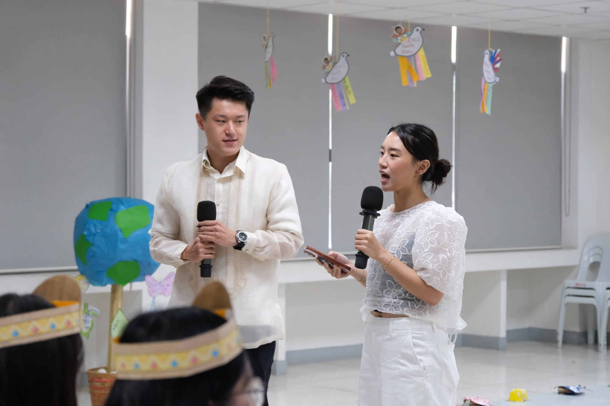 Tzu Chi Youth Alex Wu and Arabella Chong host the celebration in modern Filipiniana, he in a  barong Tagalog, and she in a baro’t saya. 