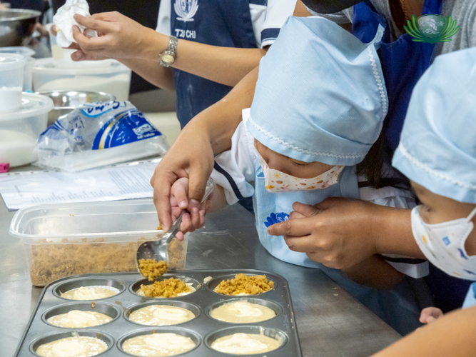 Finishing touches to the cupcakes are added generously by the happy students. 