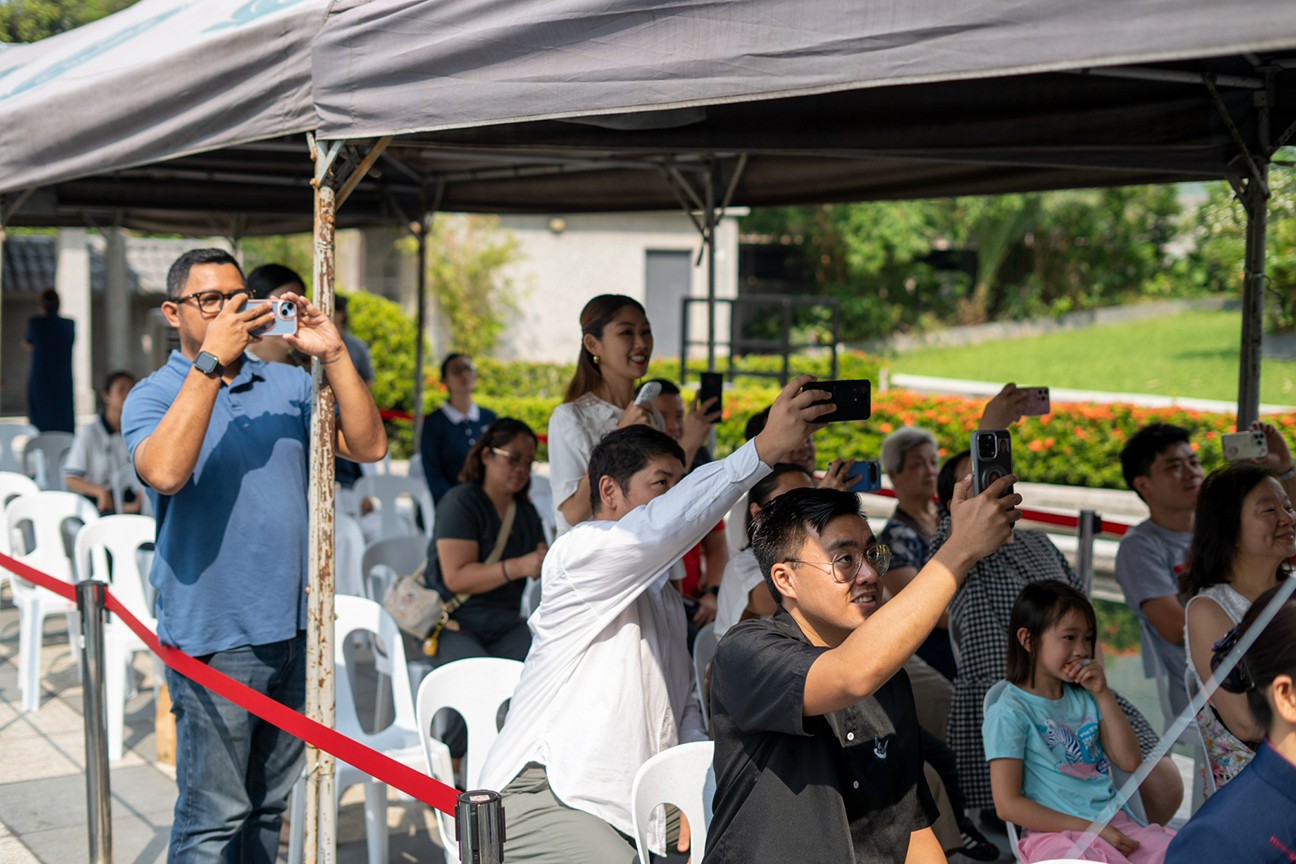 A proud and joyful moment, families capture their children’s performance on their cellphone cameras. 