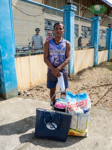 Dennis Roldan looks forward to bringing these relief items to his family, to comfort them amidst recovery.