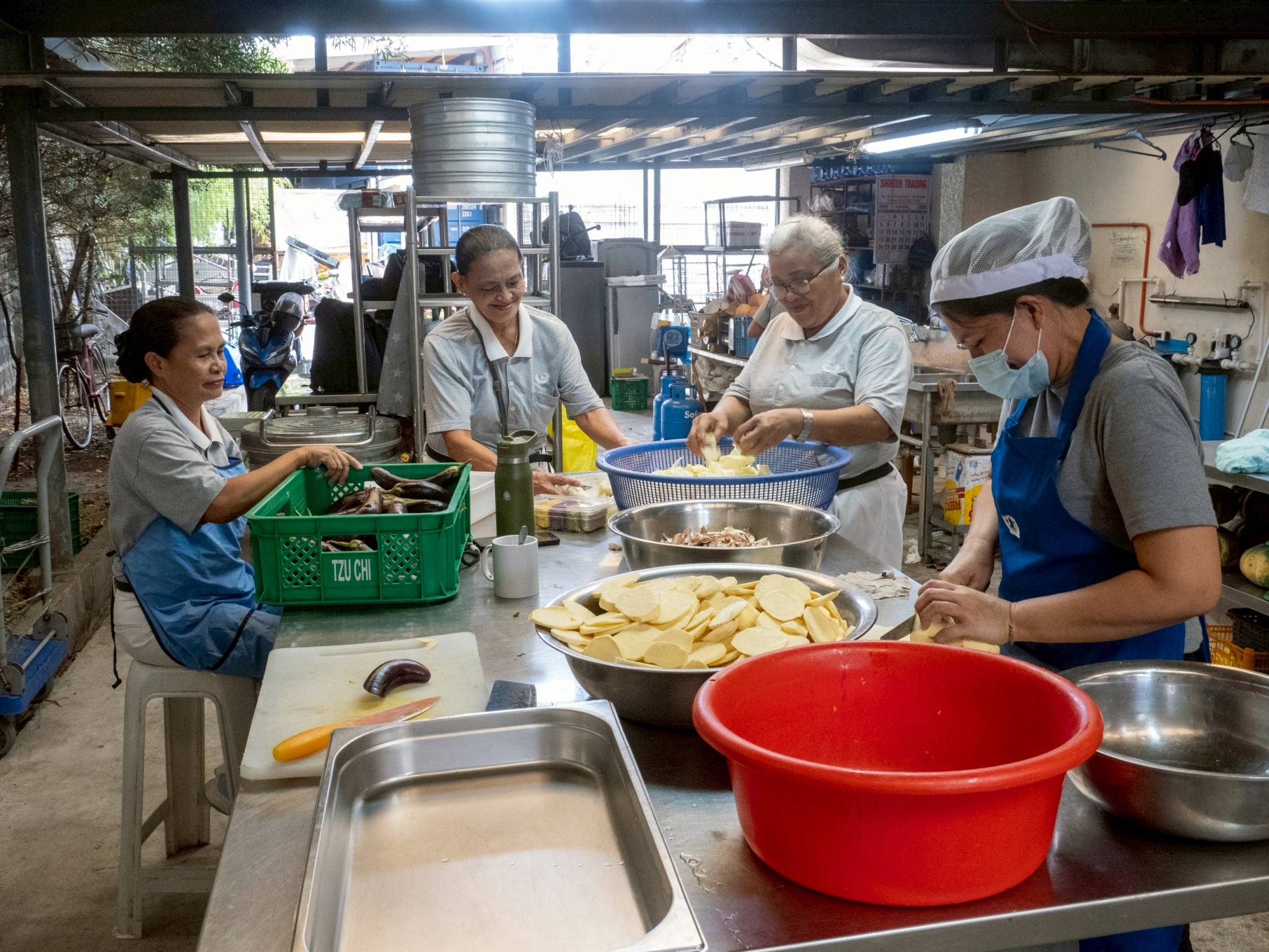 Kitchen volunteers prepare ingredients for an all-vegetarian menu. 