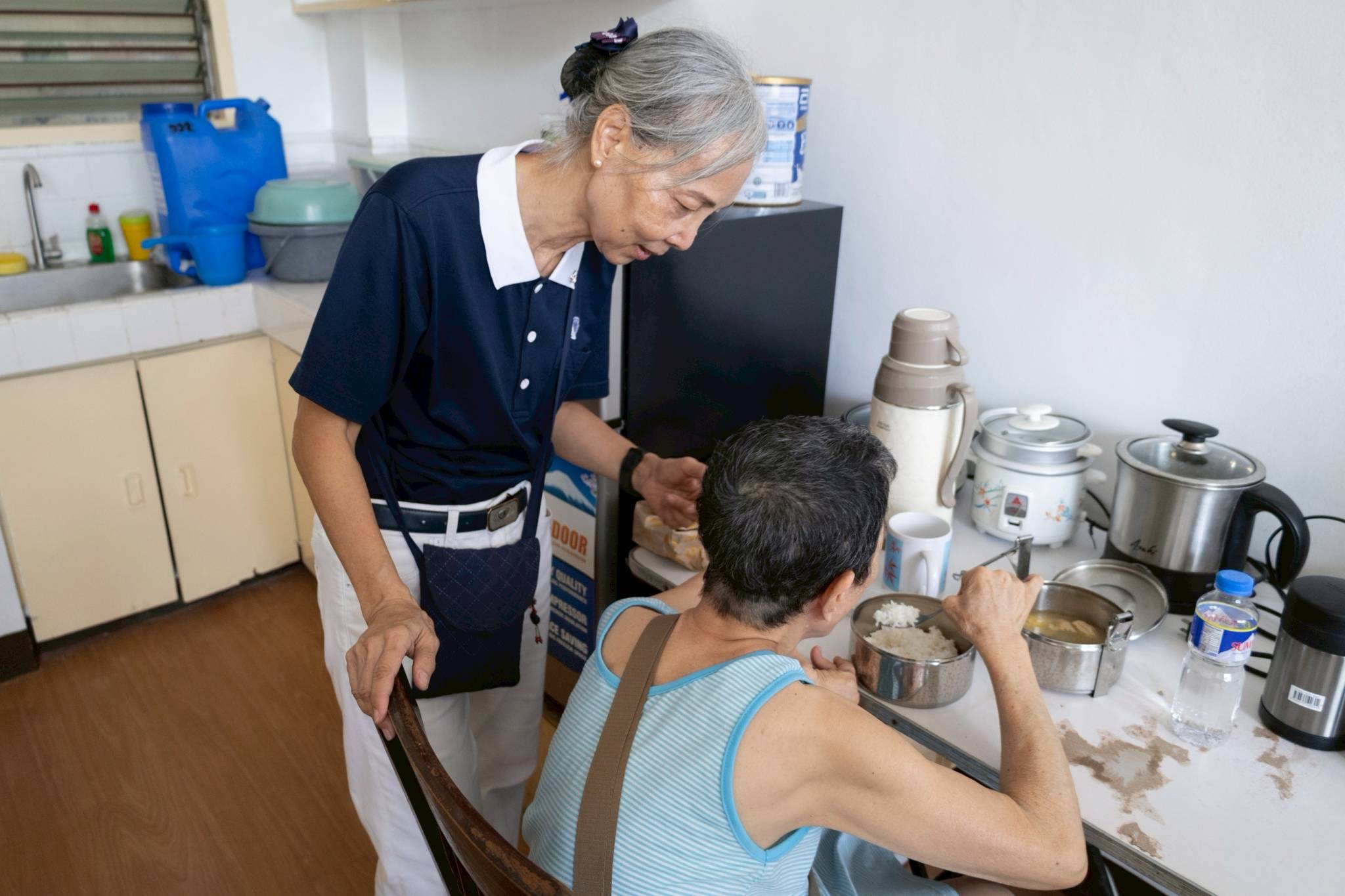 Tzu Chi volunteer Elsa Lee oversees Perla’s first lunch as she begins adjusting to the new systems and rules inside her new home.