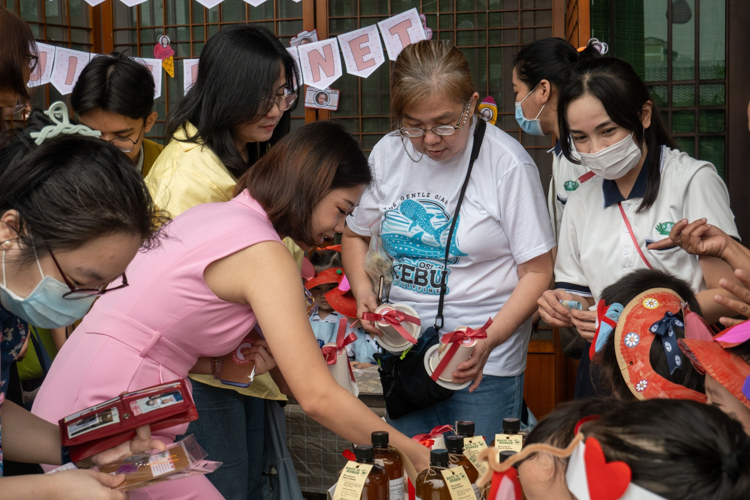 Parents and attendees happily check out the items available for sale.