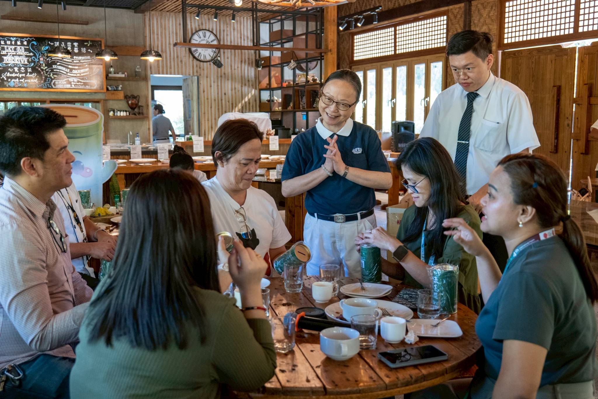 Tzu Chi staff and volunteers went from table to table to address questions about the food.