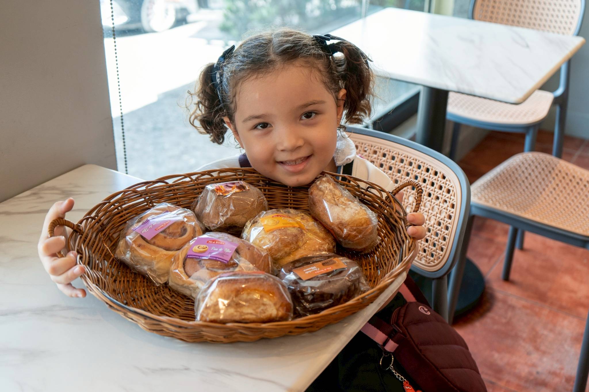 Smiles fill the breadshop as the children personally choose the bread they will bring home.