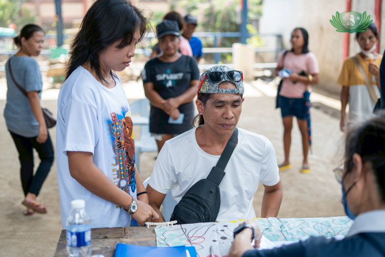 Ervil and Chervil Noble line up together to claim relief stub, seeking support after their home and belongings were completely wiped out by the flood.