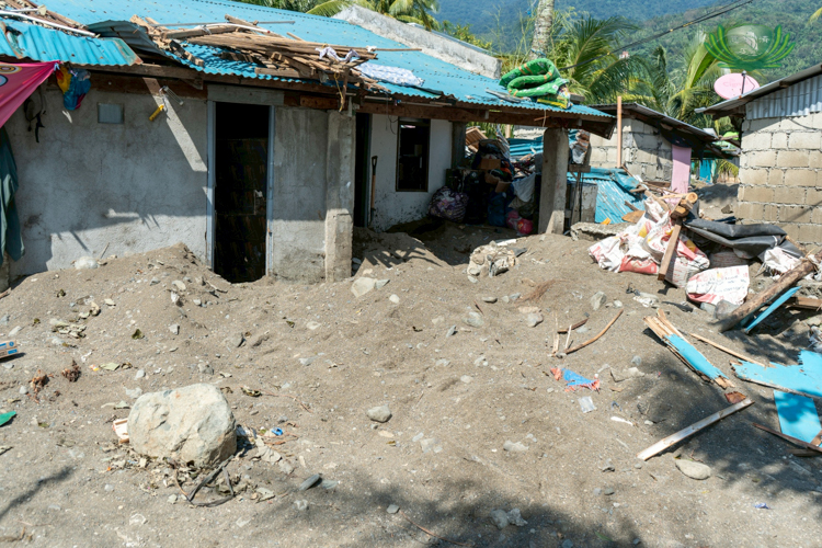Houses in Aplaya, Dingalan, are buried under at least a foot of sand after powerful storm surges from Typhoon Uwan swept through coastal communities.