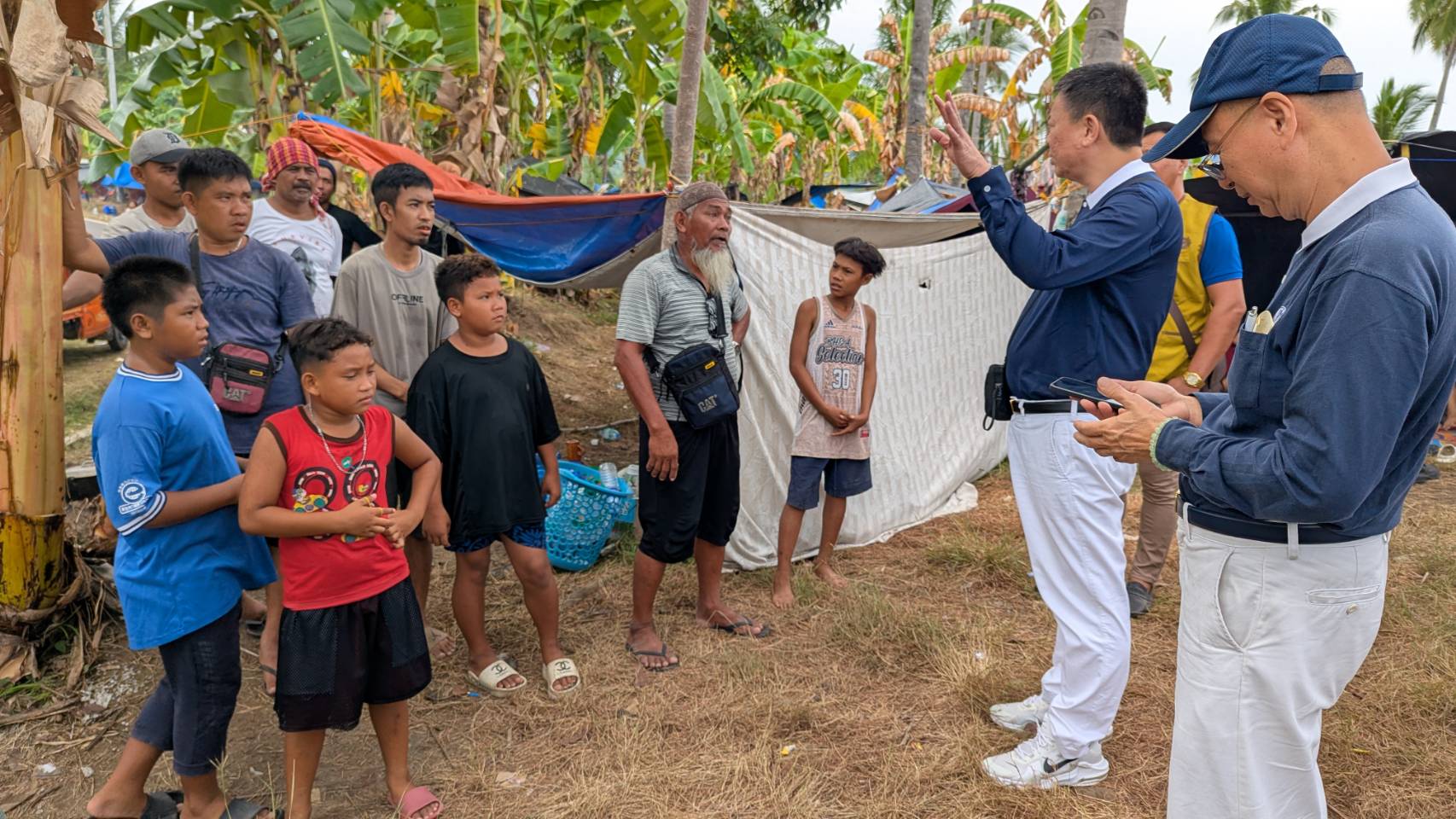 Tzu Chi Davao OIC Nelson Chua (second from right) chats with quake survivors from Glan. 