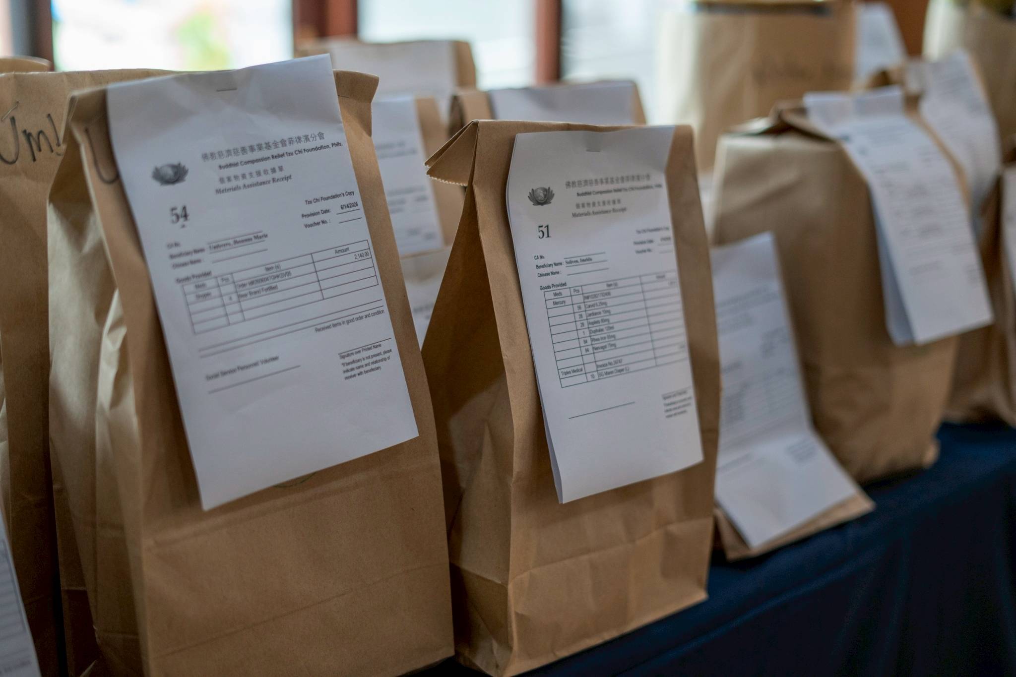 Volunteers prepare maintenance medicines for beneficiaries to pick up after Charity Day. 