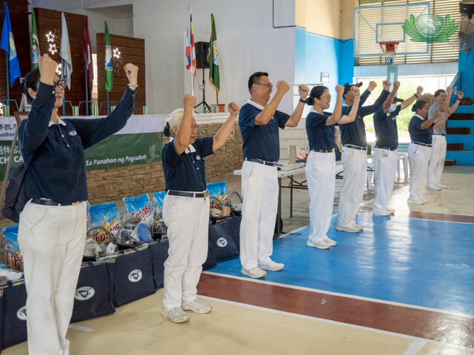 Tzu Chi volunteers perform a sign language number, highlighting the message that we are one family and should help one another.