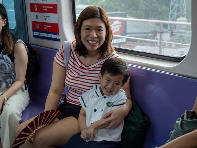 A parent and child share smiles during their LRT adventure, balancing safety with enjoyment throughout the experiential learning activity.