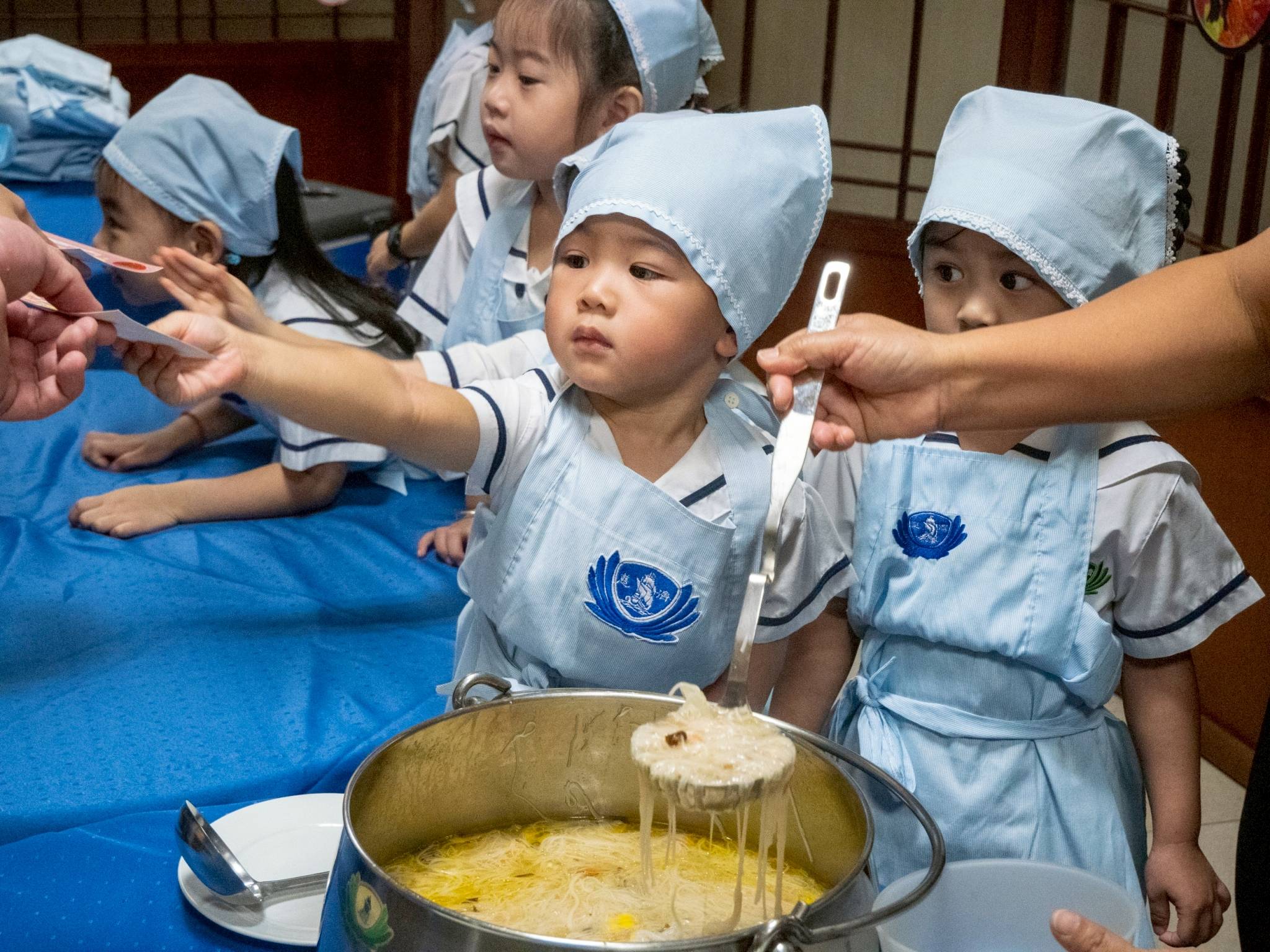 Misua was in high demand, and the children efficiently handled each payment coupon.