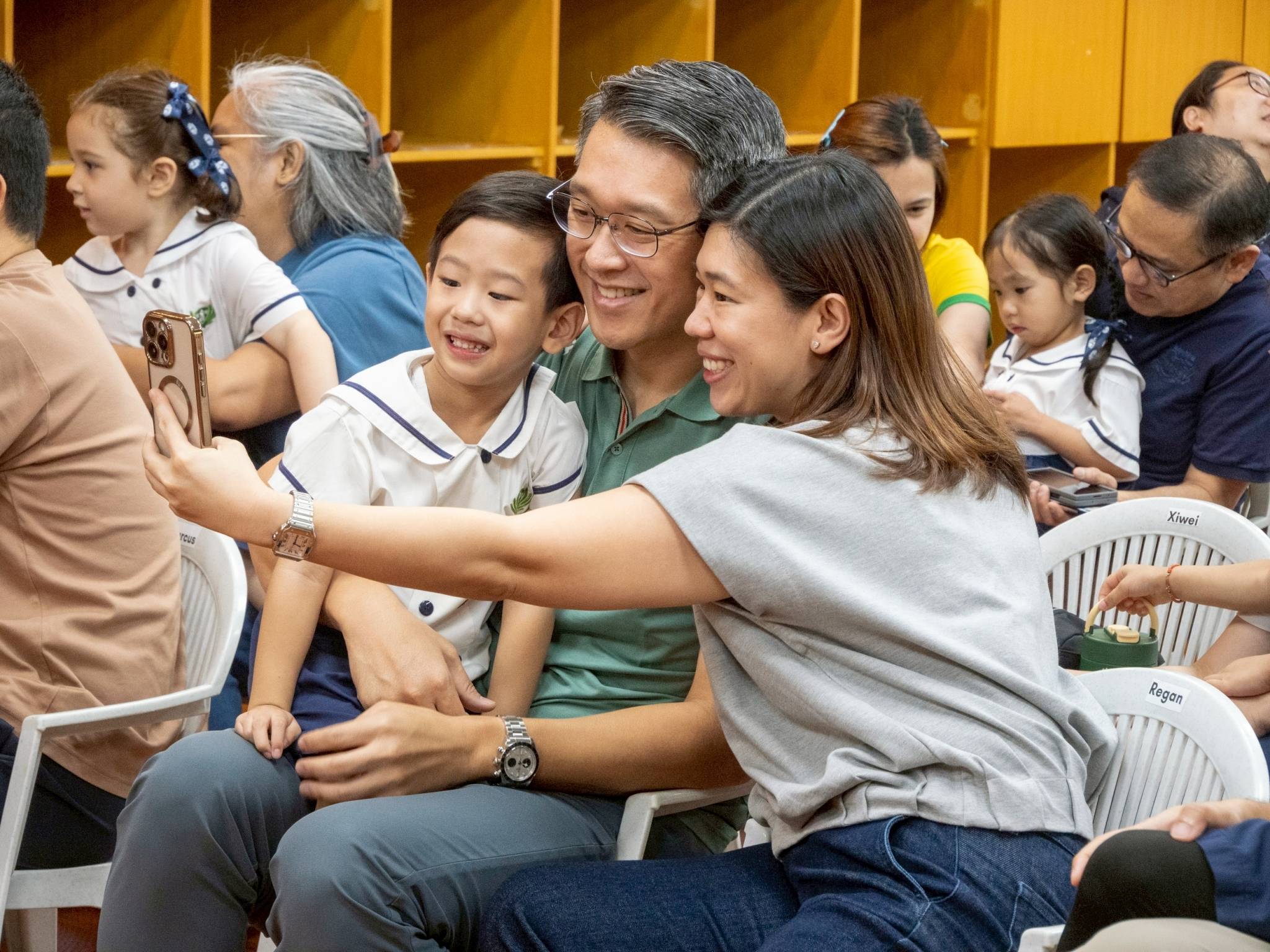 A happy family pauses for a group photo, capturing a joyful moment during the event.