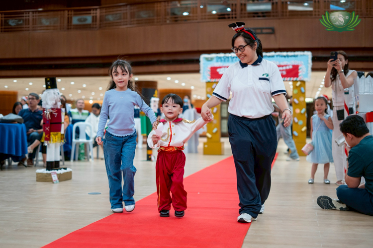 Chinese Teacher Beniliza Polican walked alongside the nursery student to guide and build their confidence.