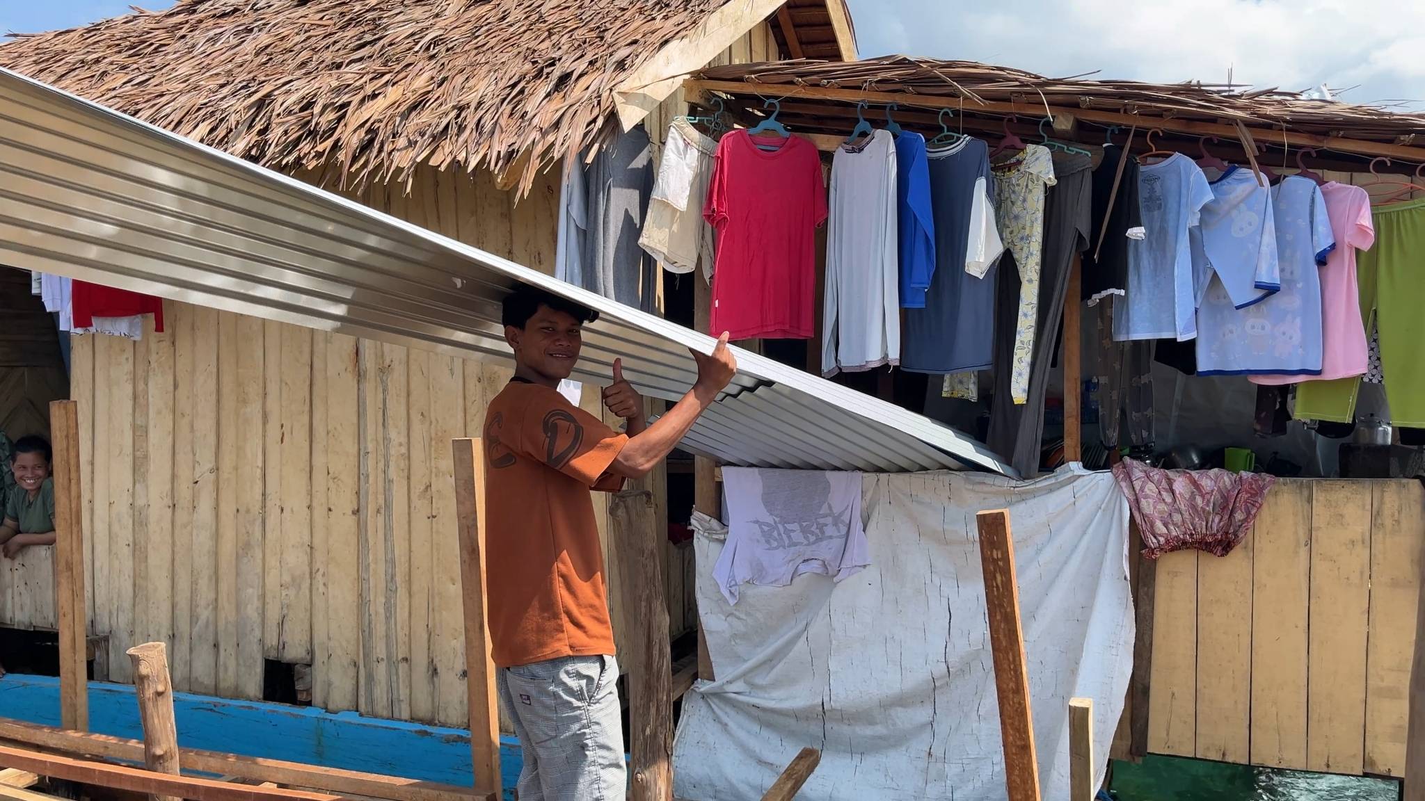 The galvanized iron sheets provide residents with materials to rebuild and improve the roof of their home.