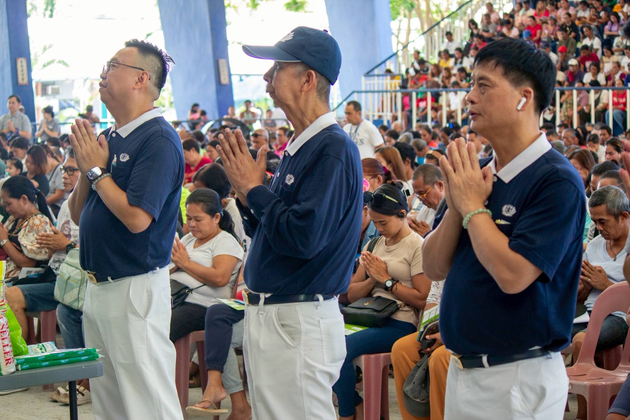 Volunteers participate in the  Tzu Chi prayer.