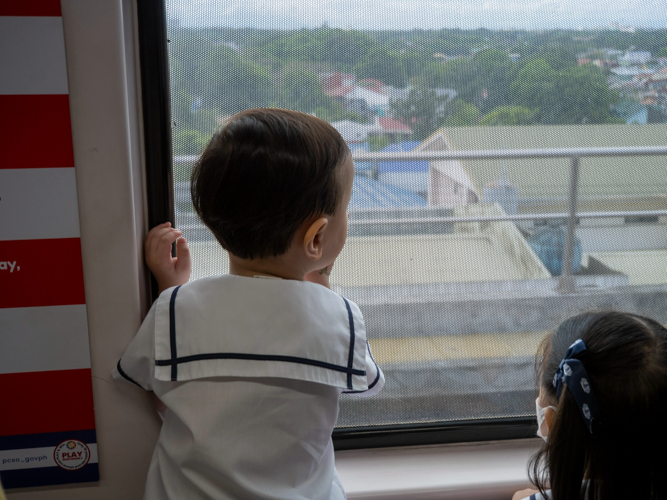 Preschoolers gaze out train windows, absorbing new perspectives and firsthand knowledge of the Philippines’ rail system.