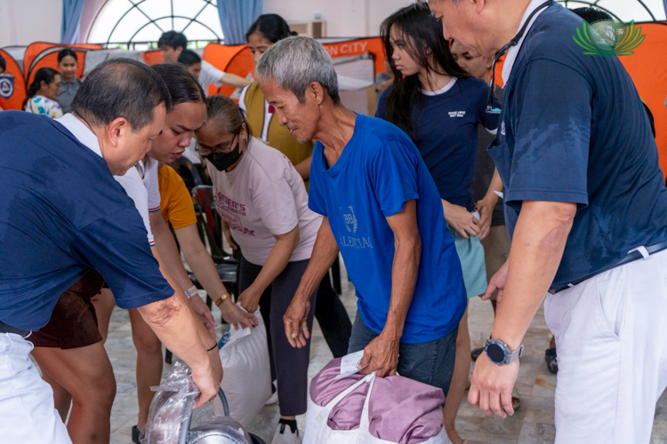 Beneficiaries receive relief goods.