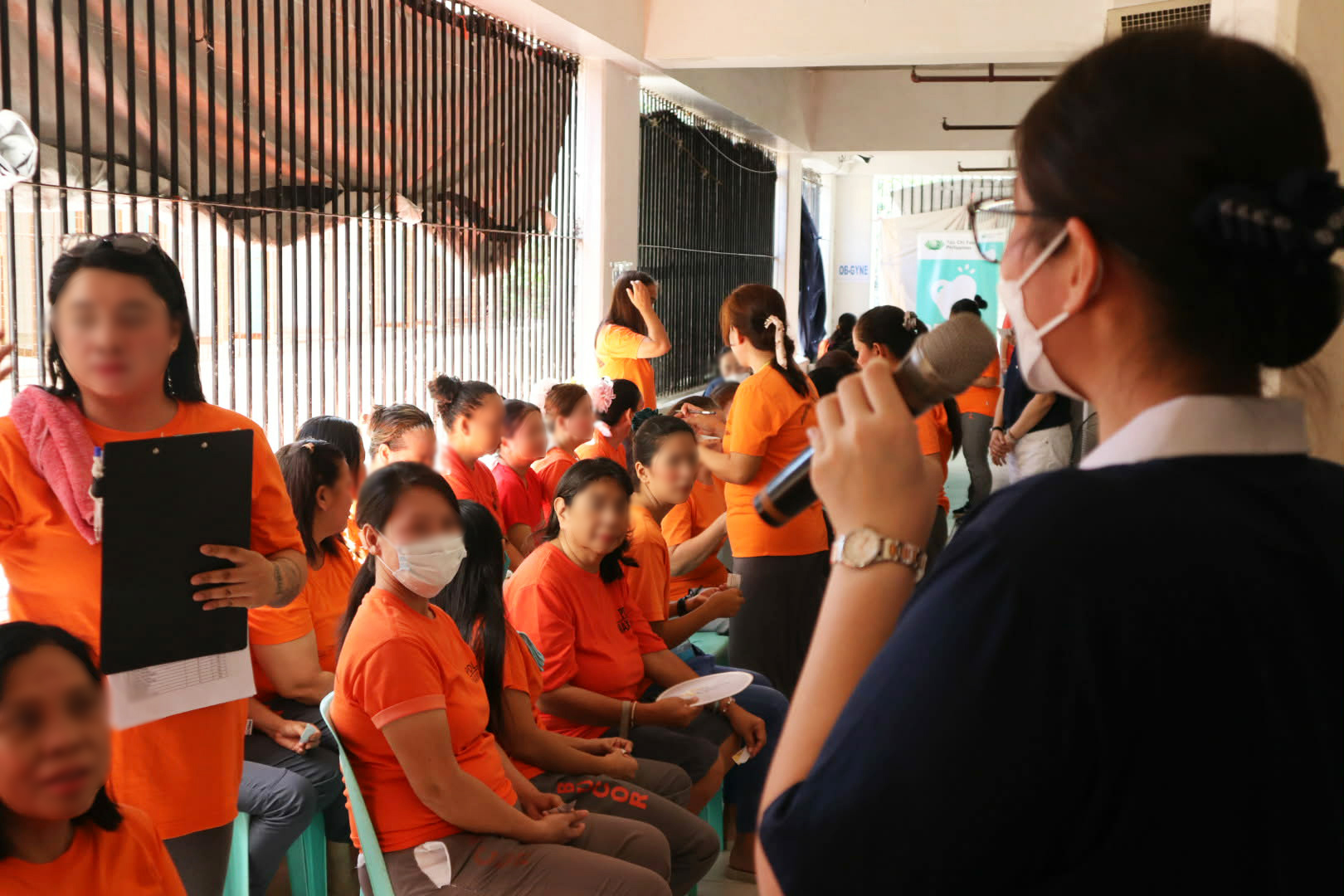 While waiting for their turn with the doctors, PDL listen to a volunteer explain the history of Tzu Chi and its founder, Dharma Master Cheng Yen. 