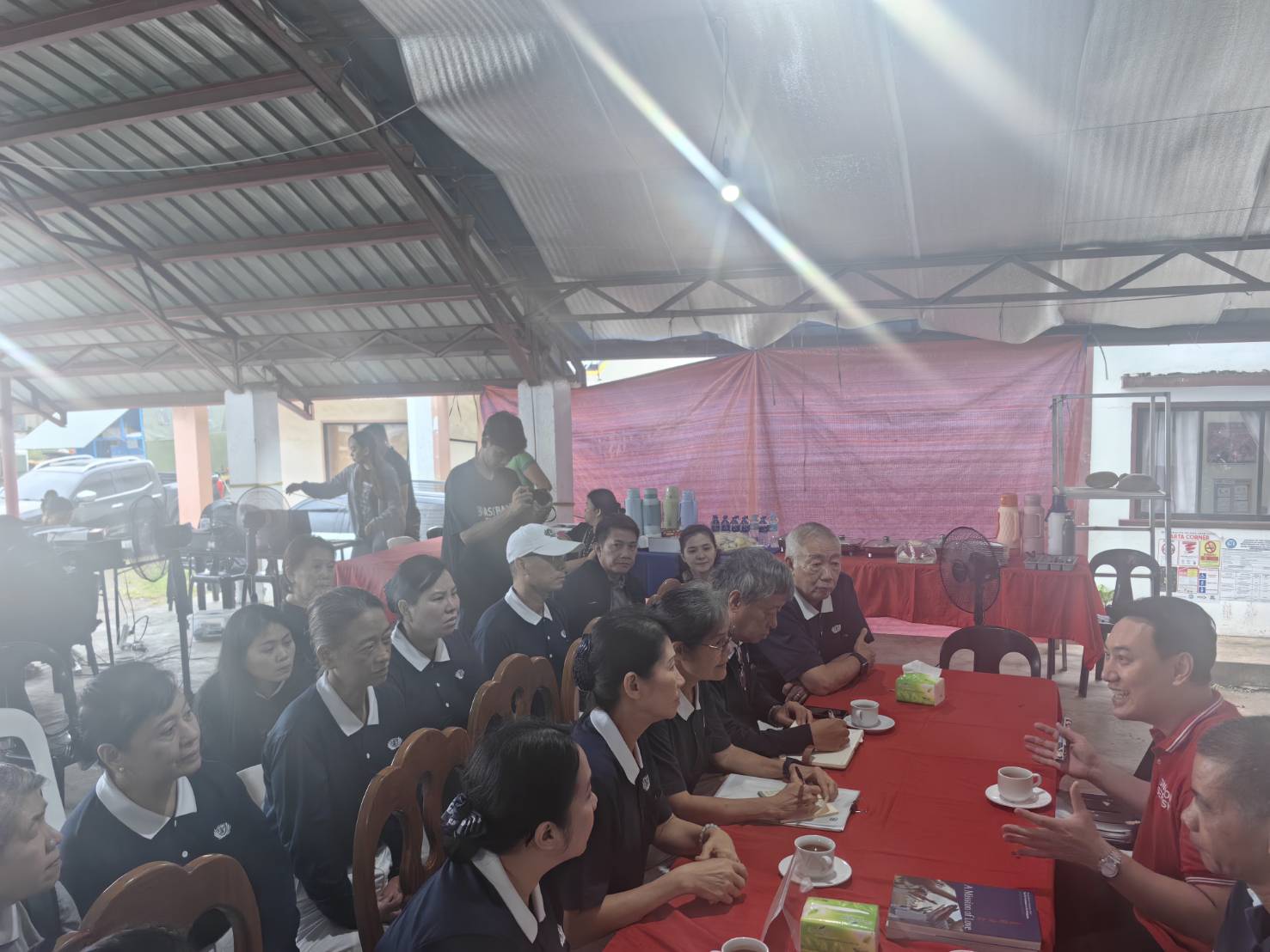 In a makeshift headquarters, Tzu Chi volunteers pay a courtesy call to Jose Abad Santos Mayor Jason John A. Joyce (in red). 