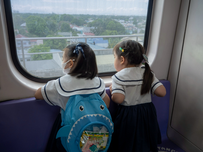 Preschoolers gaze out train windows, absorbing new perspectives and firsthand knowledge of the Philippines’ rail system.
