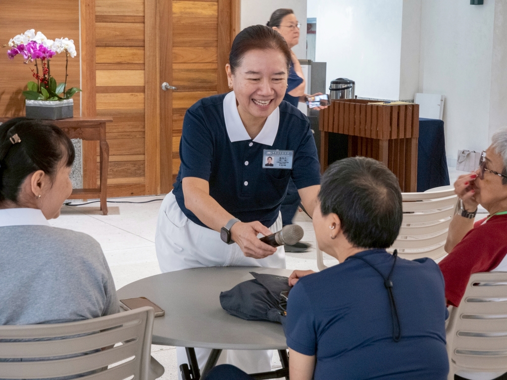 Tzu Chi volunteer Ligaya Ng encourages guests to introduce themselves in a lively ice breaker game.