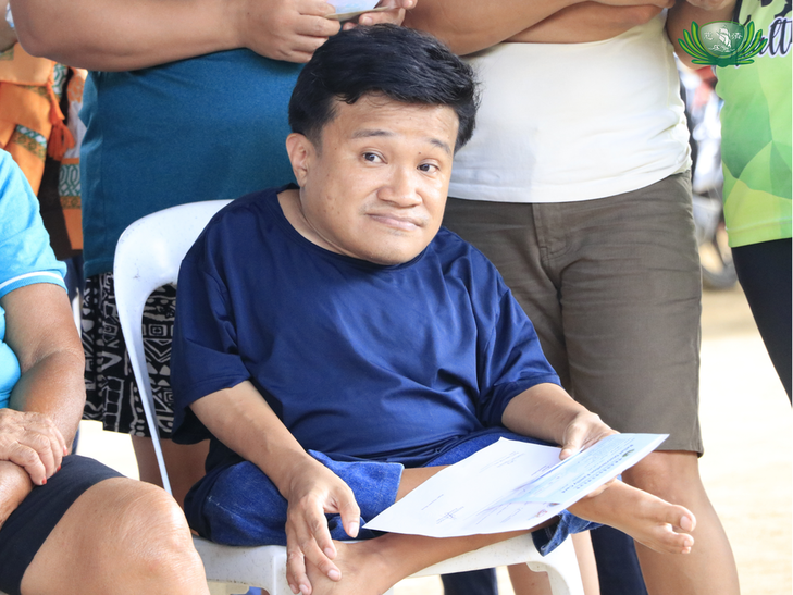 Dexter Talisik, 43, joins the relief distribution, where he received aid that would help him care for his 96-year-old grandmother. 