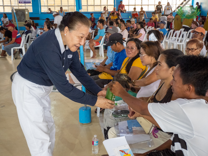 Coin cans were passed among beneficiaries to encourage giving back, symbolizing the cycle of compassion.