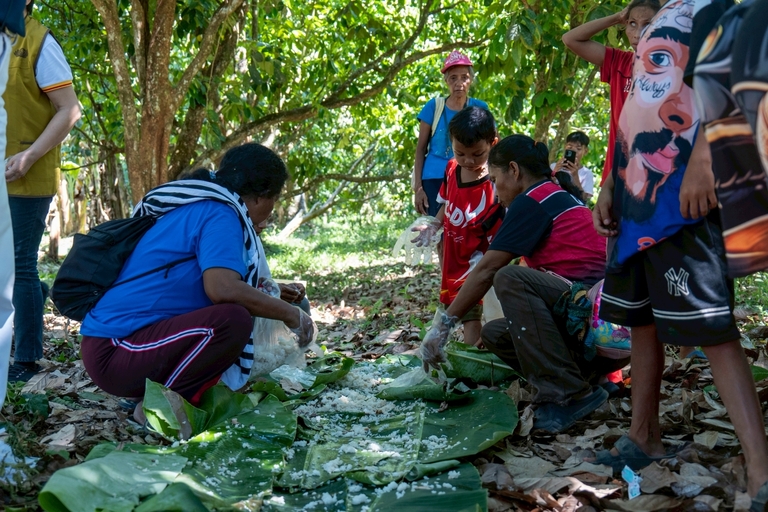In a show of community spirit, Indigenous Peoples spread banana leaves on the ground and combined their food to share a meal.