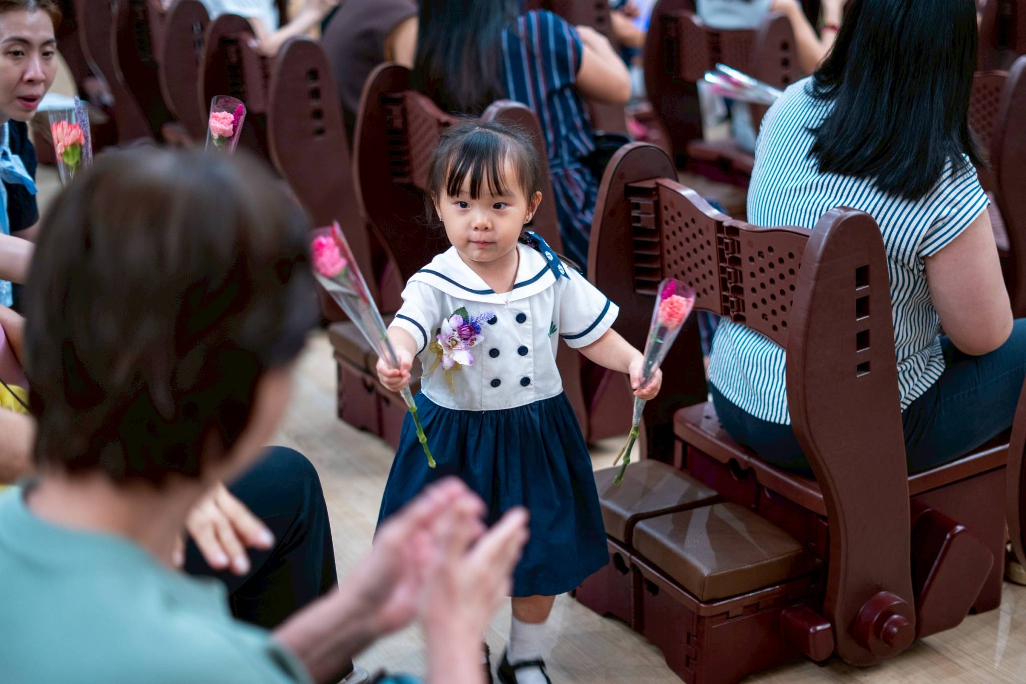 As a sign of their love and respect, students surprise their parents with long-stemmed roses.