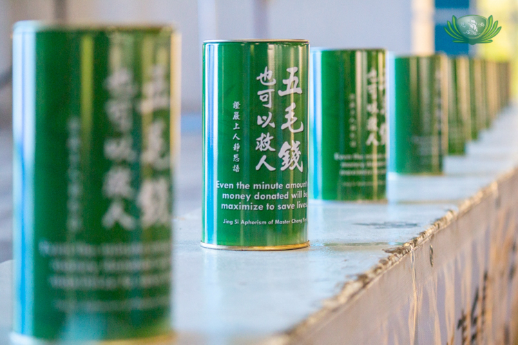 Coin cans were passed among beneficiaries to encourage giving back, symbolizing the cycle of compassion.