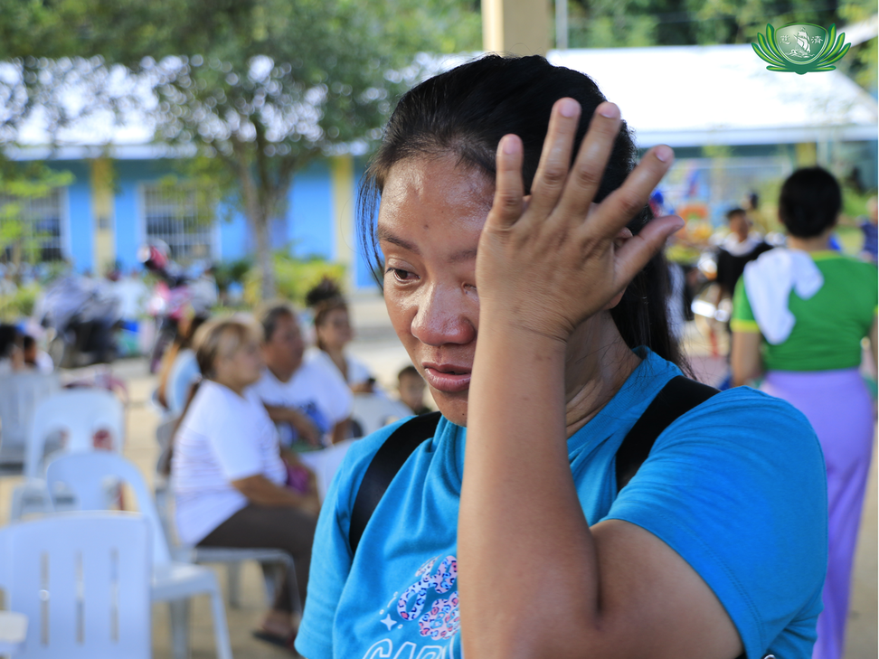 Jessa Bihag from Cabadiangan, Compostela, cries as she shares her story during the relief distribution. For her, this aid is instrumental in their recovery as they find the strength to begin once more.