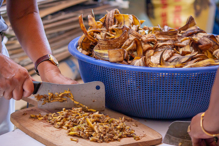 After washing, volunteers chop the banana peels as part of the process to make eco-enzyme【Photo by Marella Saldonido】