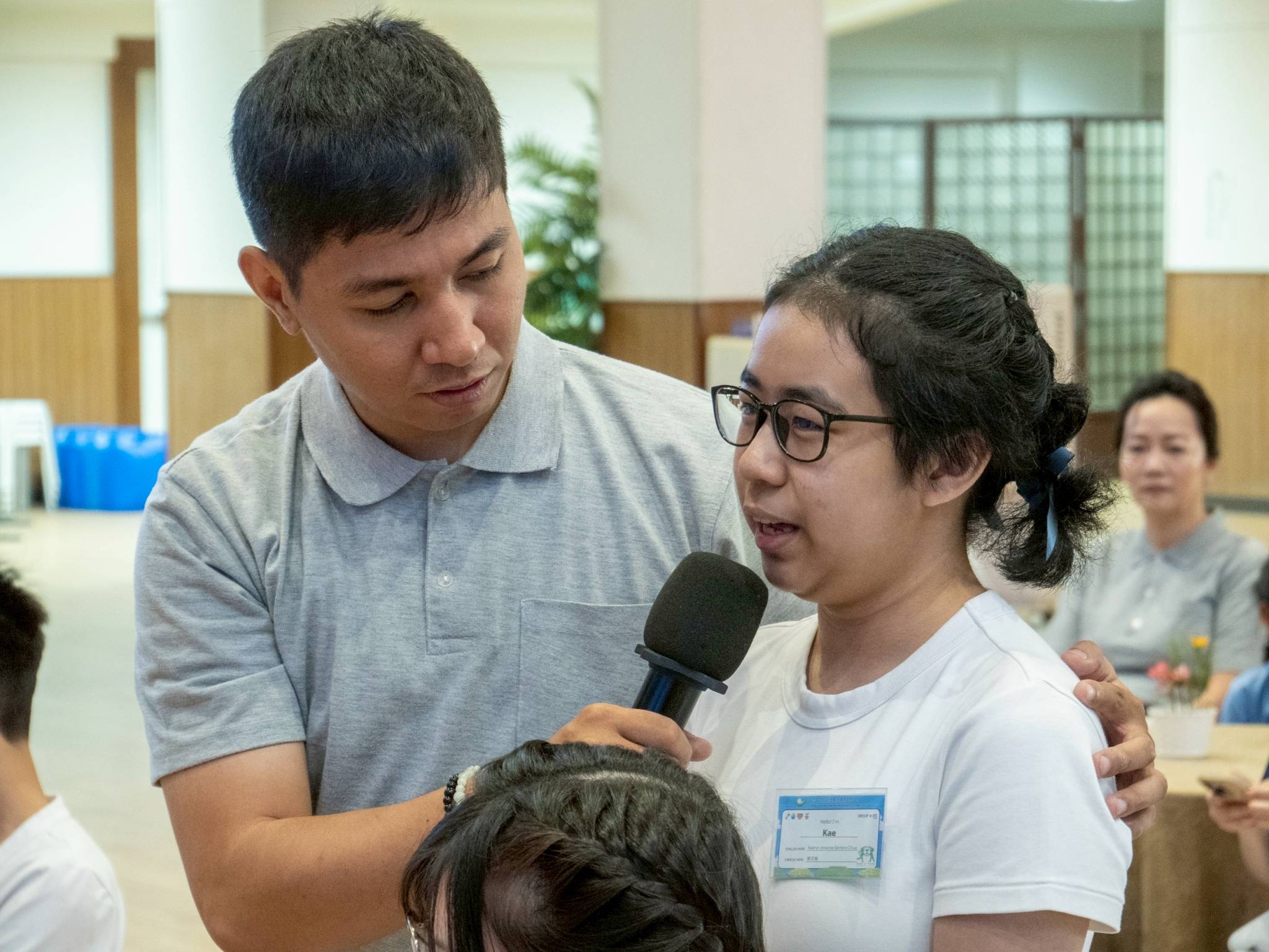 Tzu Chi volunteer Jamil Carvajal listens as camper Kaeryn Arriane Chua shares her experience volunteering with Tzu Chi Youth. 
