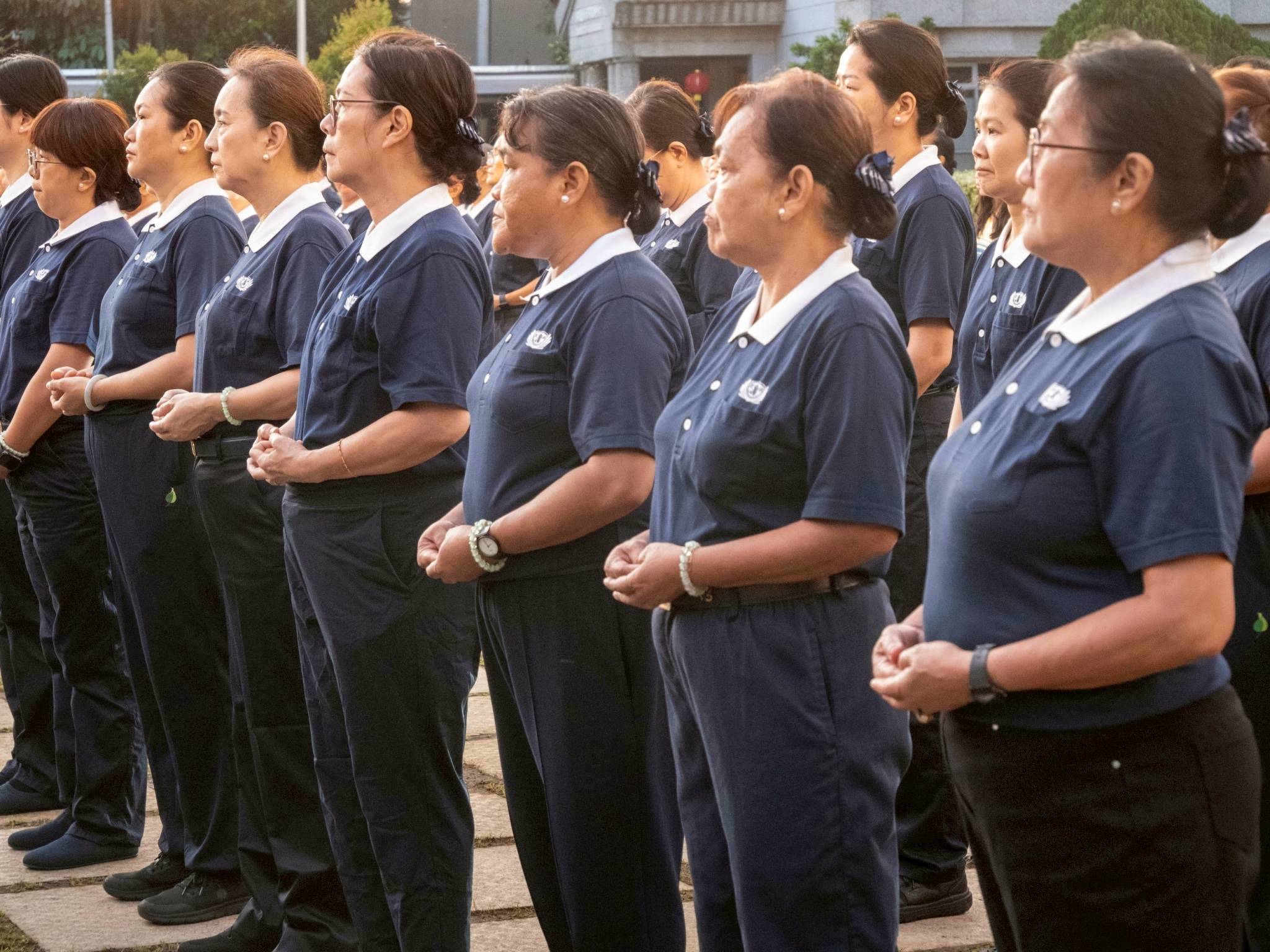 With quiet discipline, Tzu Chi volunteers form a line as the ceremony is about to commence.