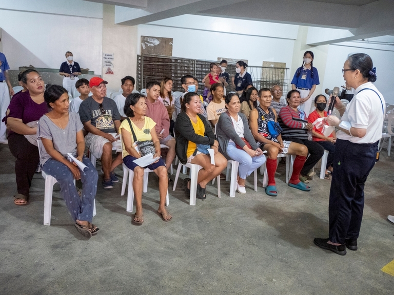 Patients listen to an educational talk on dental care while waiting for their turn.