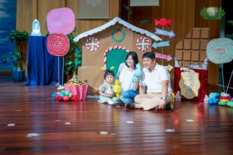 The Tan family poses at the Nutcracker-themed stage, showing they are kids at heart as they enjoy their daughter’s learning journey.