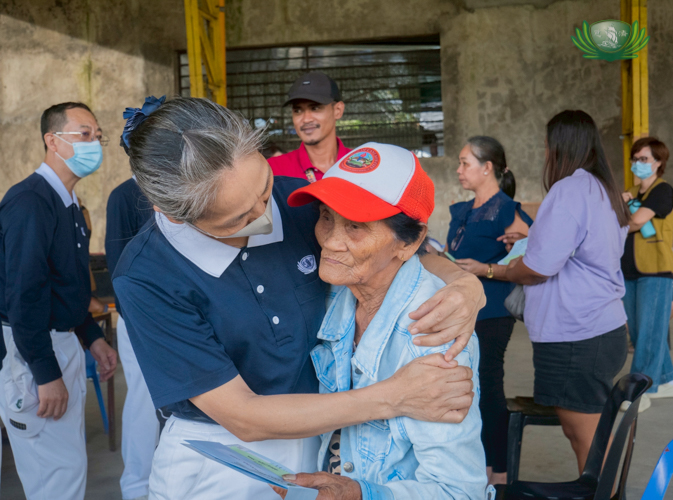 A Tzu Chi volunteer embraces a resident from Canlaon City, offering quiet comfort and compassion in the aftermath of loss.