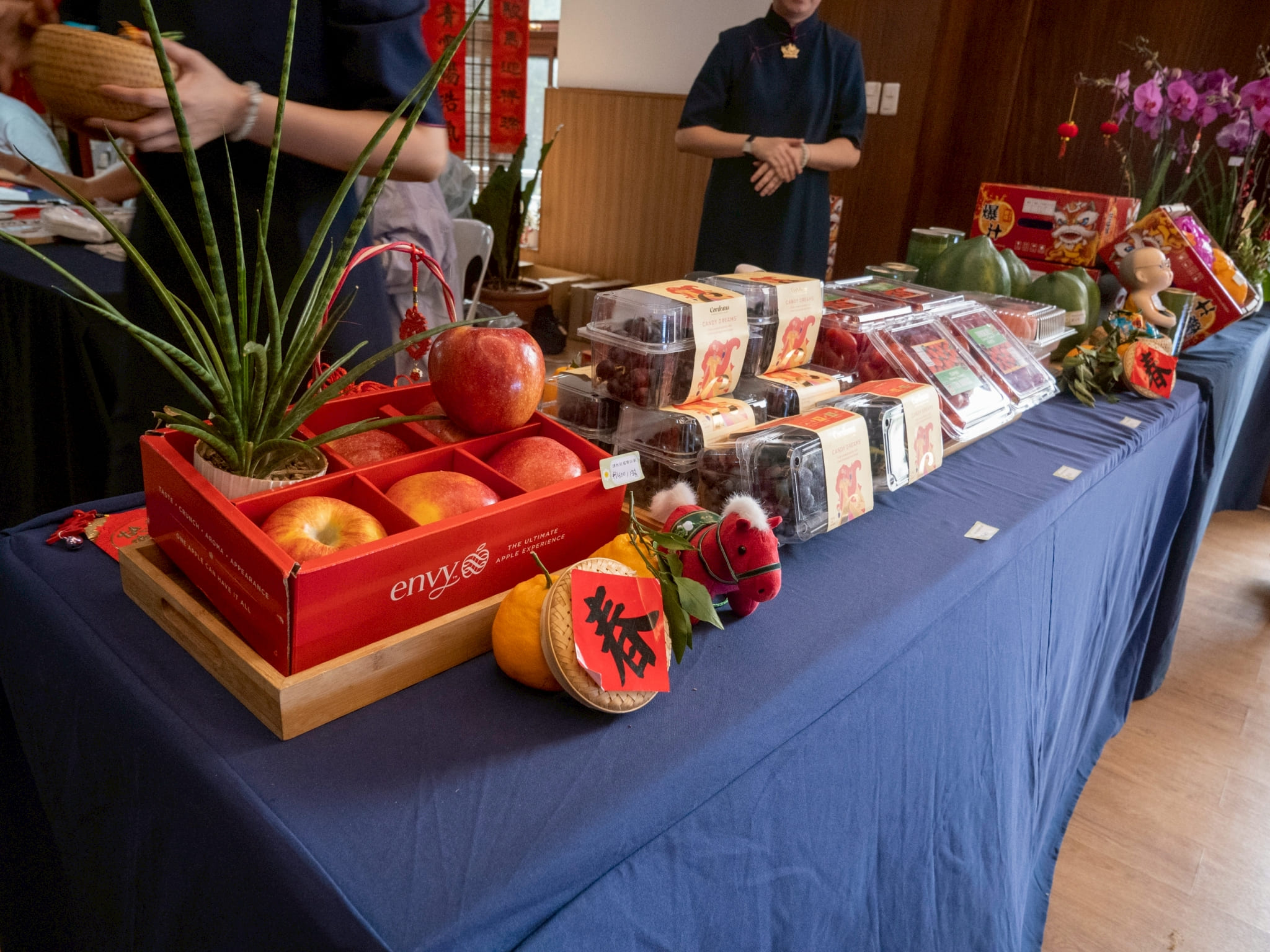 Tokens of luck—round red fruits, candies, a stuffed toy horse—were on sale at the entrance of the hall. 