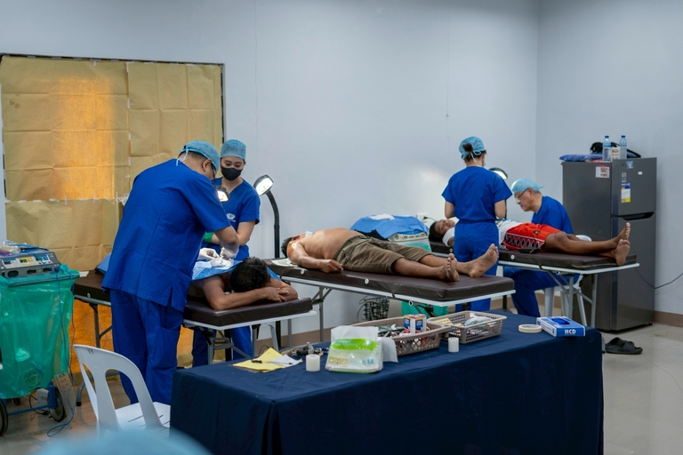 Minor surgical procedures are performed simultaneously by TIMA’s volunteer doctors in a makeshift operating room at the Victoria Plaza Hotel in Victoria, Oriental Mindoro.