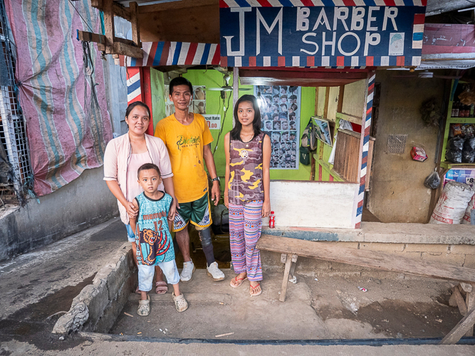 Prosthesis recipient Joey Bolandrina (in yellow shirt) poses for a family portrait.