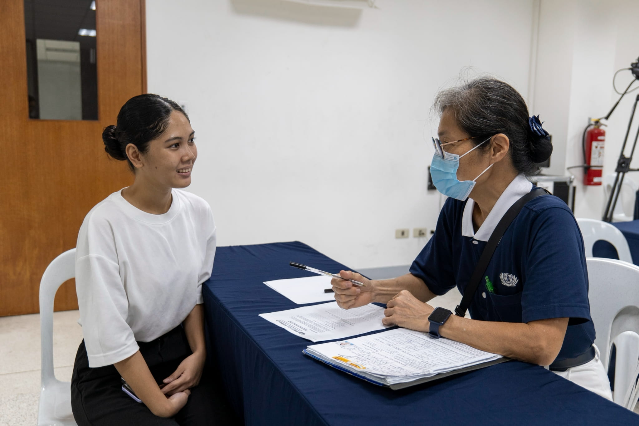 Now with a job in Makati, Tzu Chi Iloilo scholar Daniella Diane Simran (left) drops by BTCC for her exit interview with Tzu Chi volunteer Elvira Chua. 